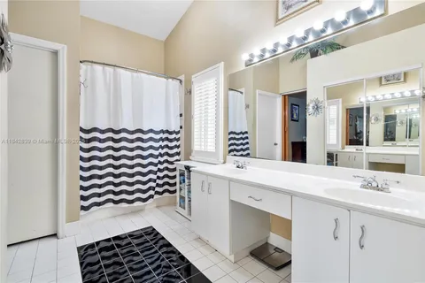 a bathroom with a sink a mirror and a shower