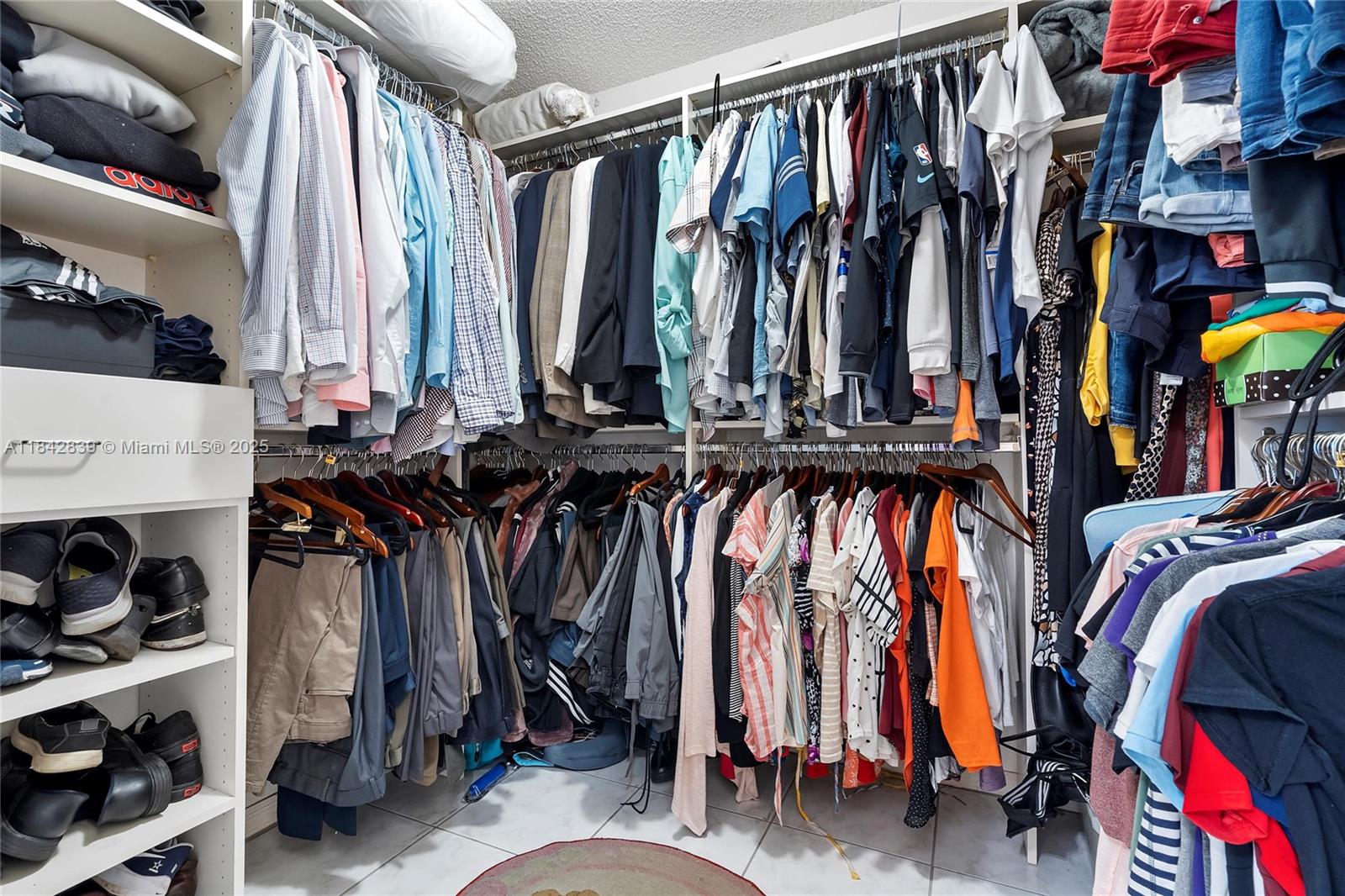 1841 Southwest 124th Way Miramar, FL 33027 - Photo 28 of 34 a view of walk in closet with clothes and shoes