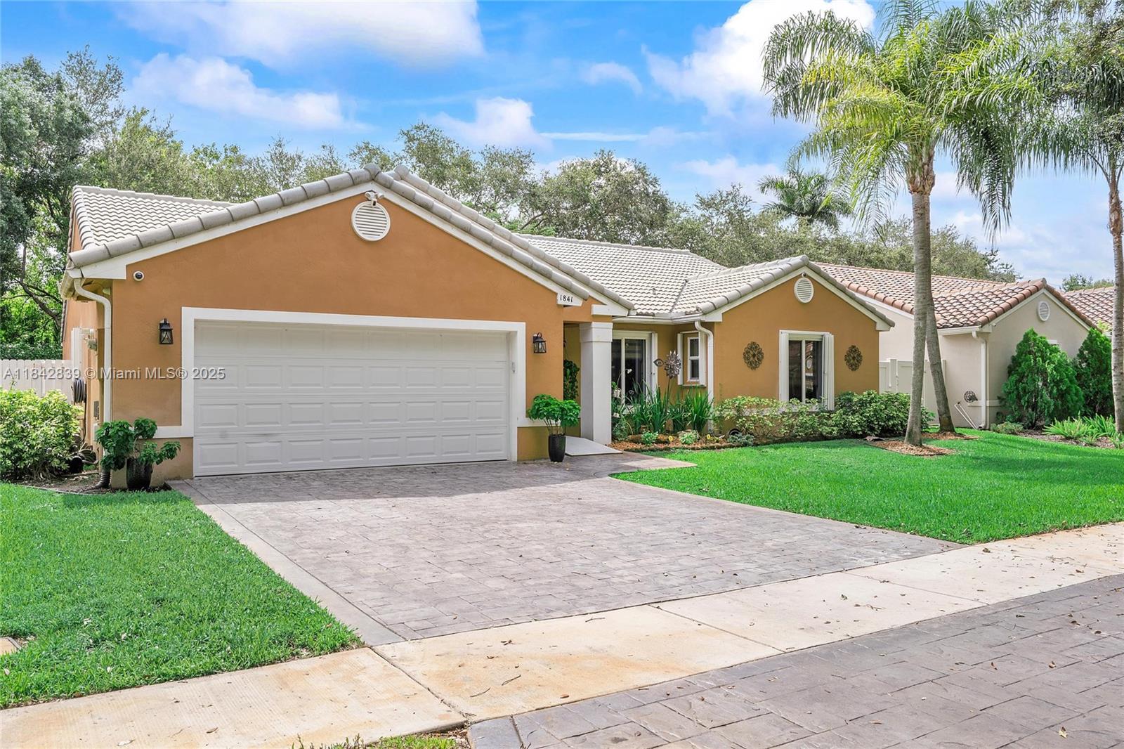 1841 Southwest 124th Way Miramar, FL 33027 - Photo 3 of 34 a front view of a house with a garden and trees