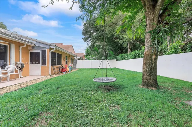 a view of a house with backyard porch and garden