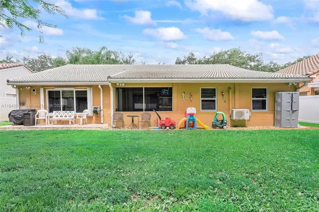 a view of a house with backyard porch and furniture