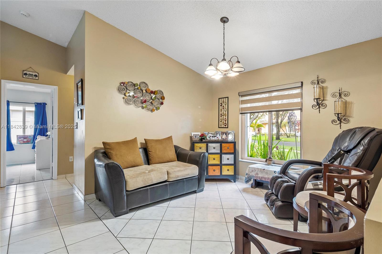 1841 Southwest 124th Way Miramar, FL 33027 - Photo 6 of 34 a living room with furniture and a large window