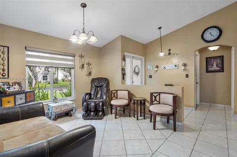 a living room with furniture a window and a chandelier
