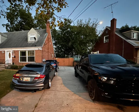 a view of a backyard with wooden fence