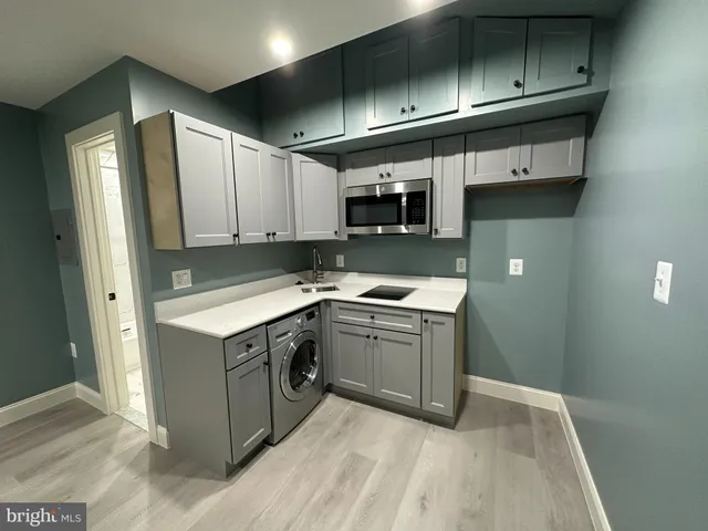 a kitchen with stainless steel appliances granite countertop a sink and a stove top oven
