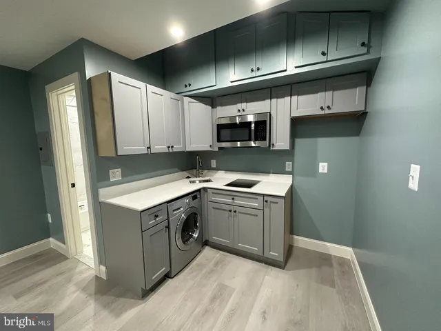 a kitchen with stainless steel appliances granite countertop a sink and a stove top oven
