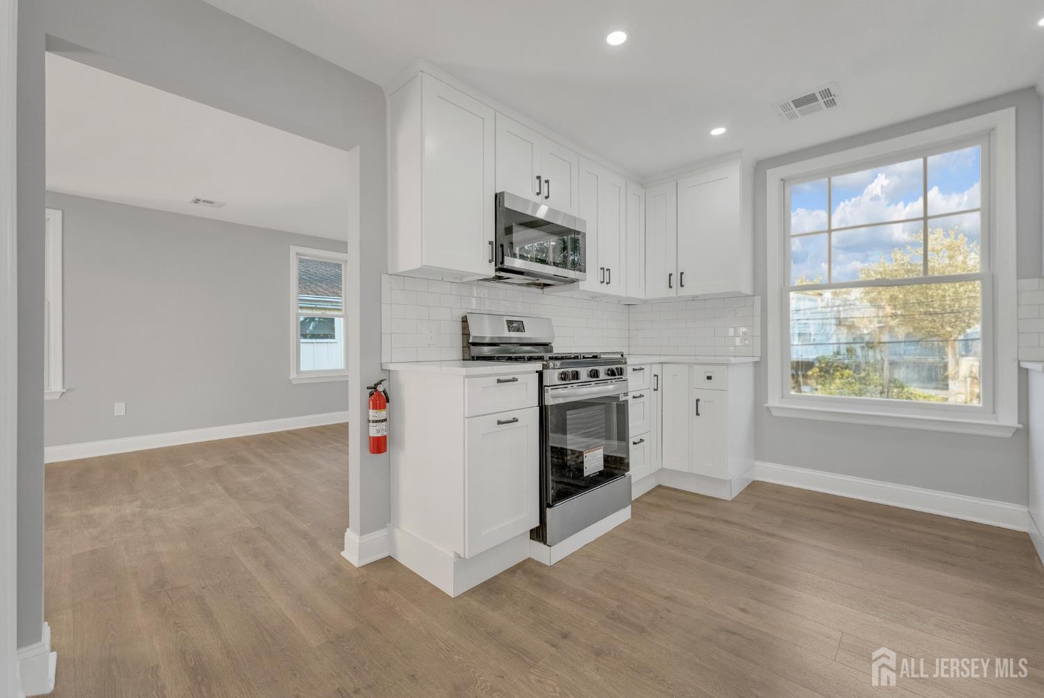15 North Main Street, Unit B Pennington, NJ 08534 - Photo 4 of 16 a kitchen with stainless steel appliances granite countertop a stove a sink and a microwave
