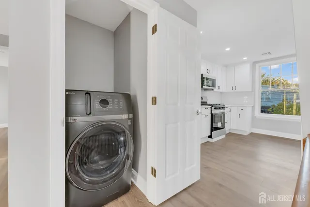 a view of a kitchen with washer and dryer