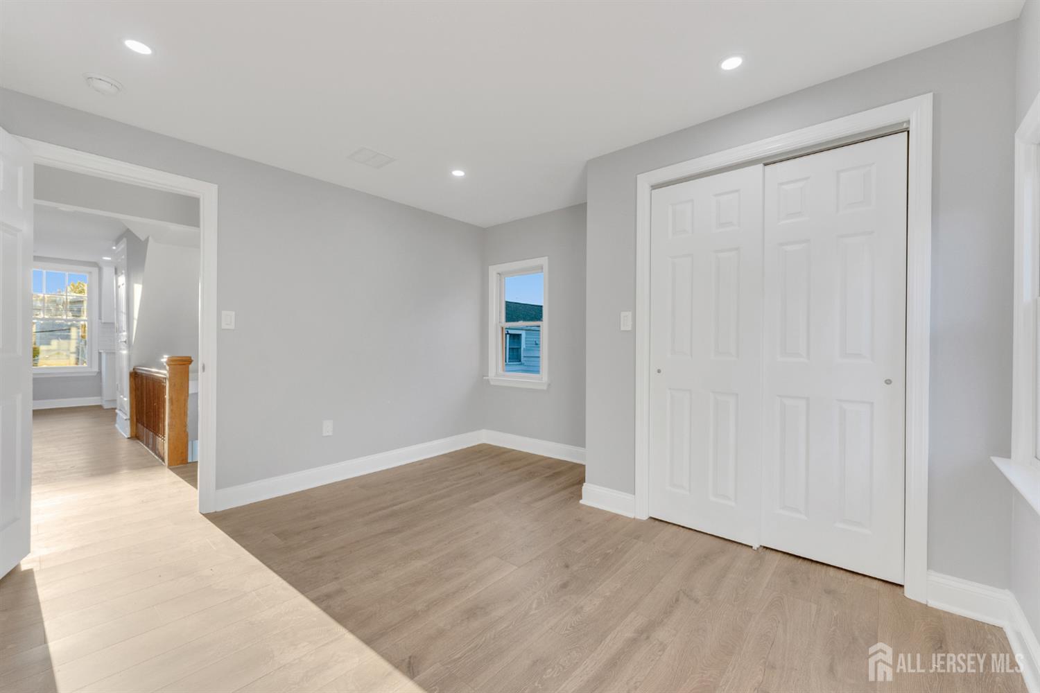 15 North Main Street, Unit B Pennington, NJ 08534 - Photo 9 of 16 an empty room with wooden floor and windows