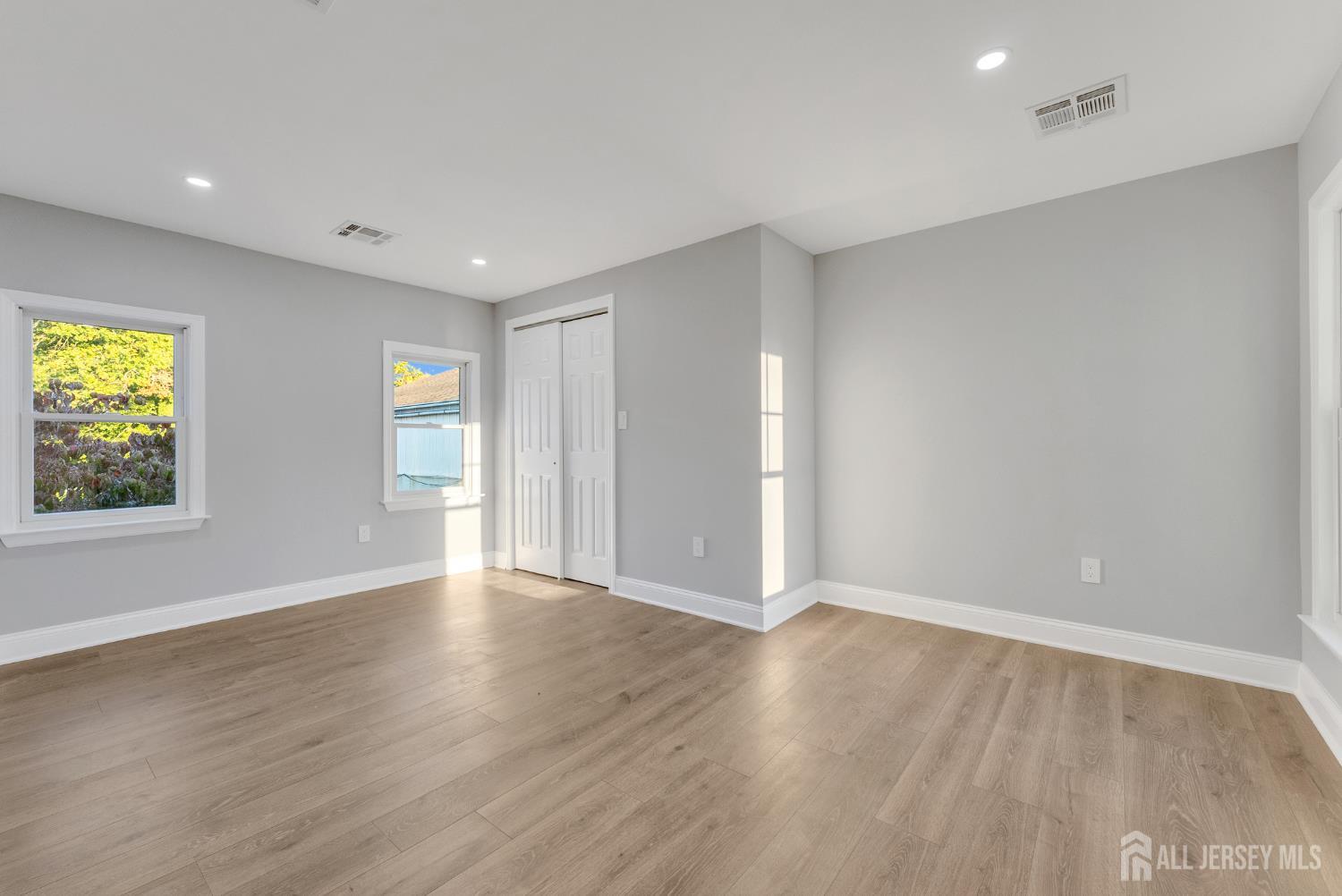 15 North Main Street, Unit B Pennington, NJ 08534 - Photo 10 of 16 a view of an empty room with wooden floor and a window