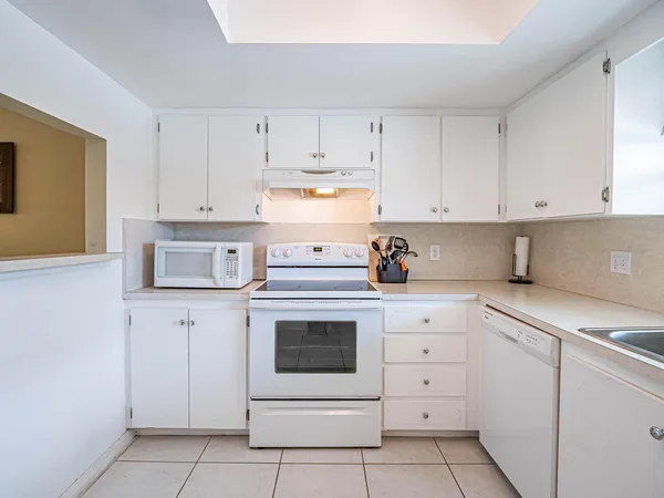 a kitchen with cabinets appliances and a sink