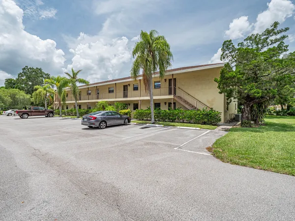 a car parked in front of white building