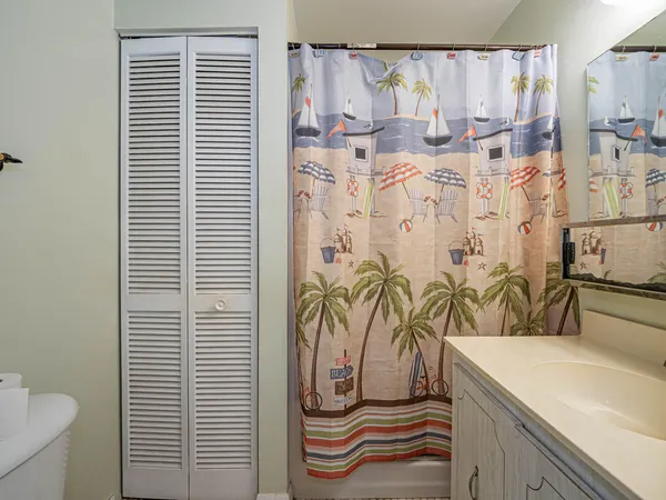 a bathroom with a shower curtain and a sink