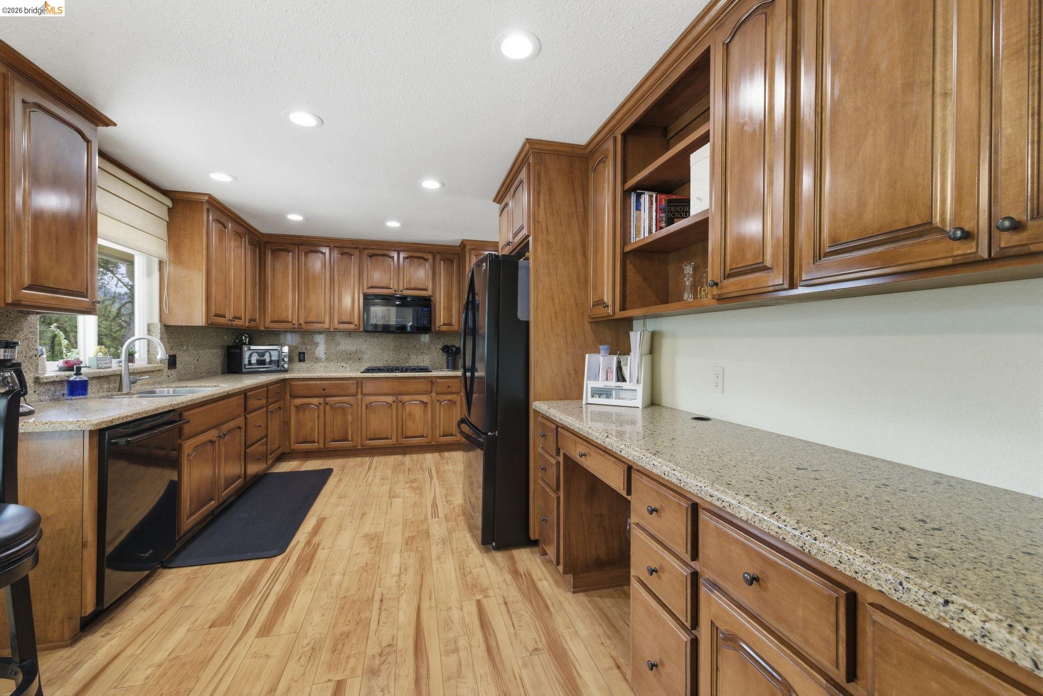 21955 Fallview Drive Sonora, CA 95370 - Photo 12 of 32 a kitchen with stainless steel appliances granite countertop wooden cabinets a refrigerator and a sink