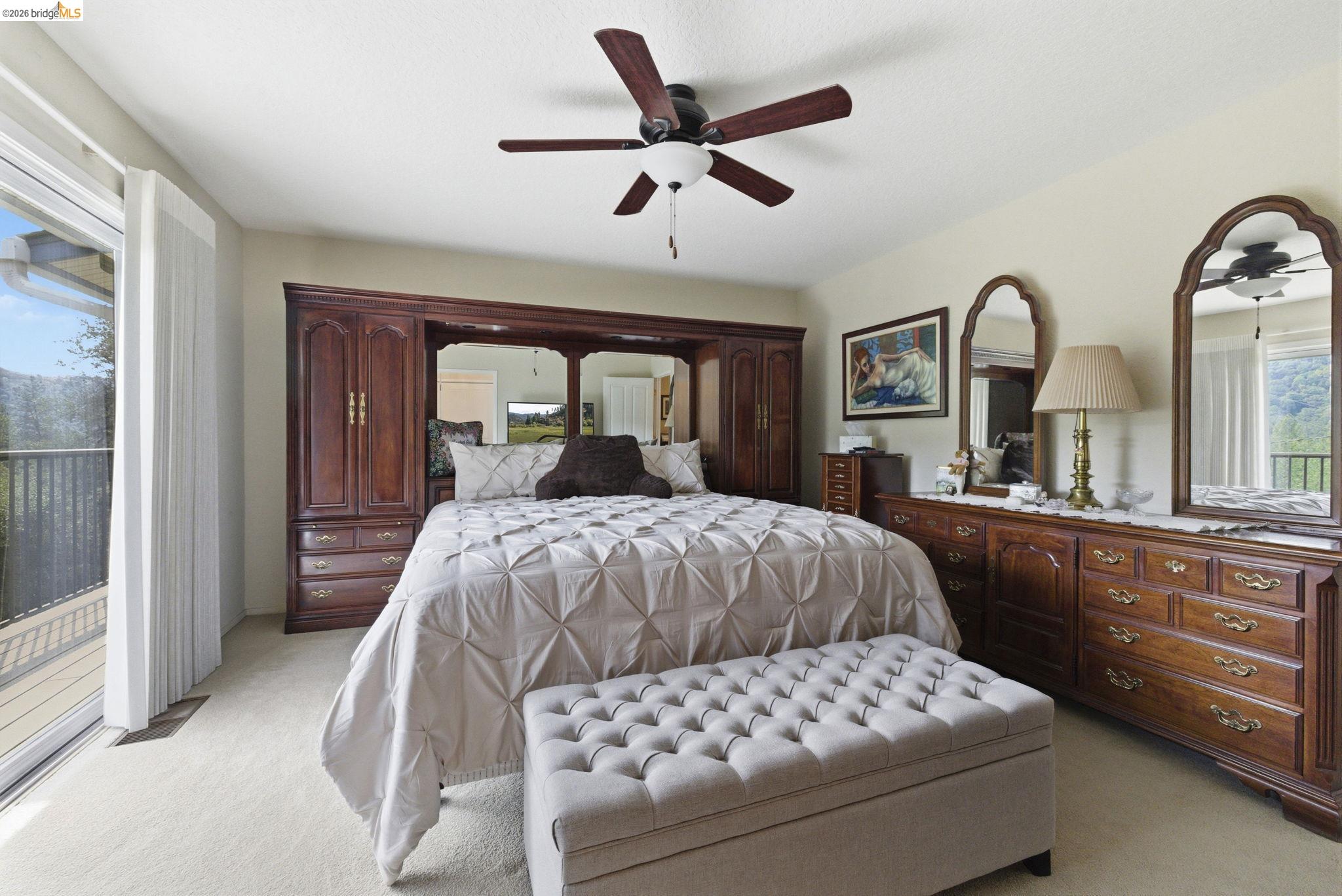 21955 Fallview Drive Sonora, CA 95370 - Photo 14 of 32 a bedroom with a large bed and a large window