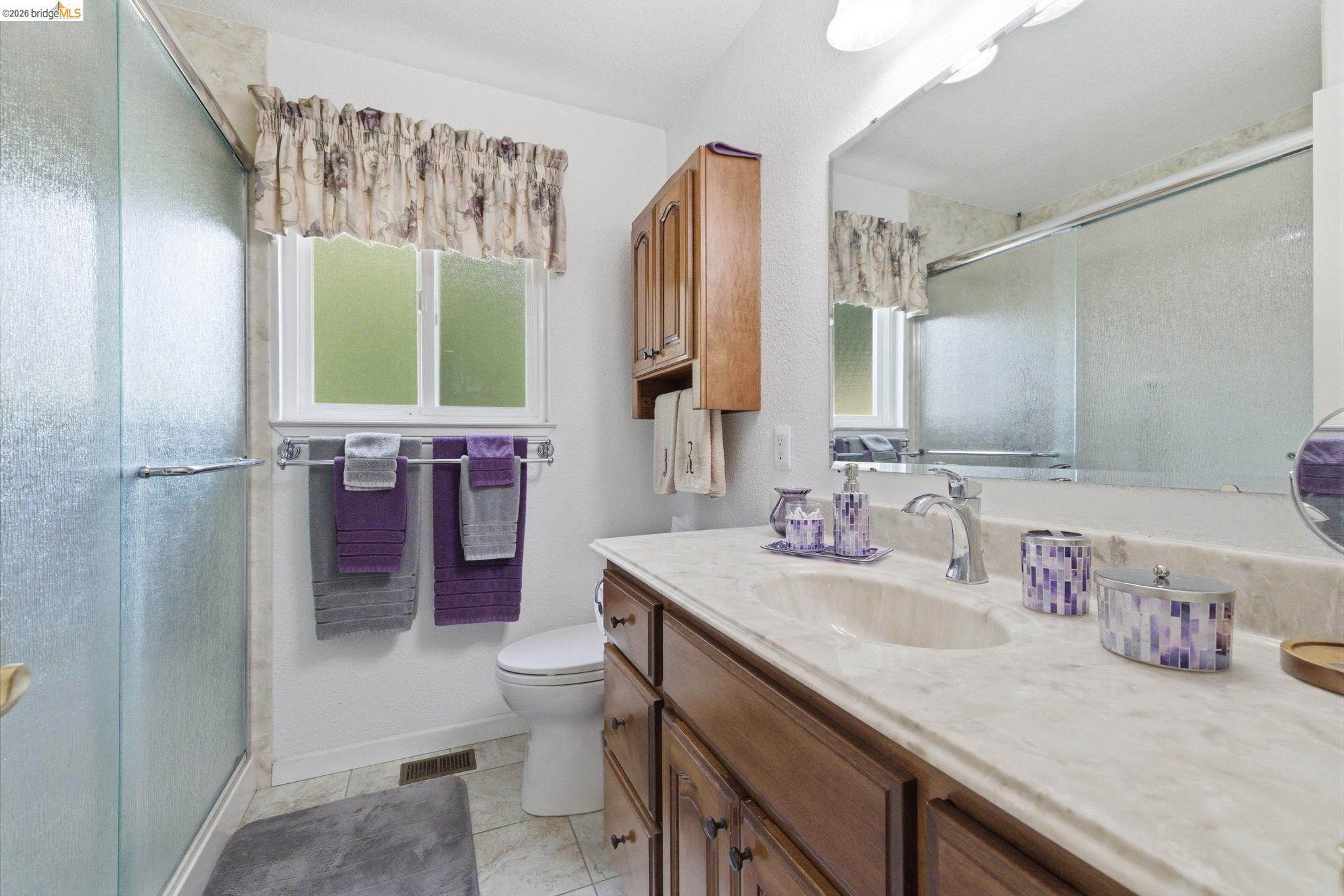 21955 Fallview Drive Sonora, CA 95370 - Photo 17 of 32 a bathroom with a sink a toilet and a mirror