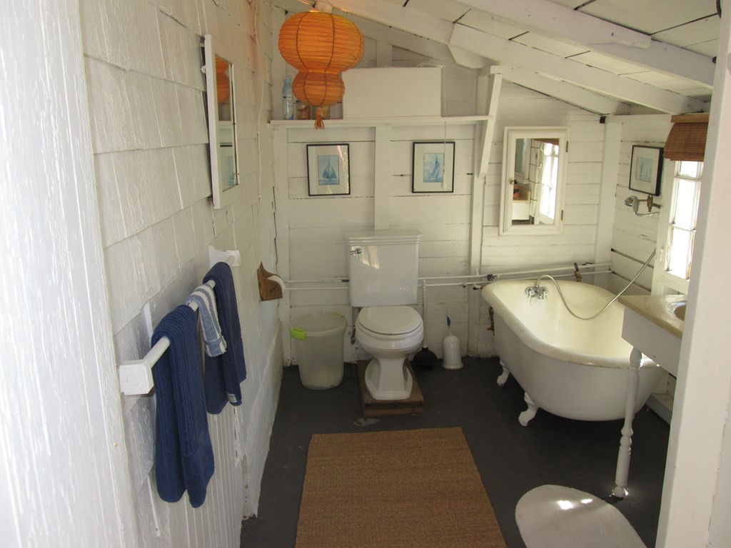 39 North Neck Road Edgartown, MA 02539 - Photo 18 of 26 a bathroom with a toilet sink and mirror