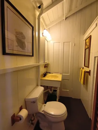 a bathroom with a toilet a sink and tub