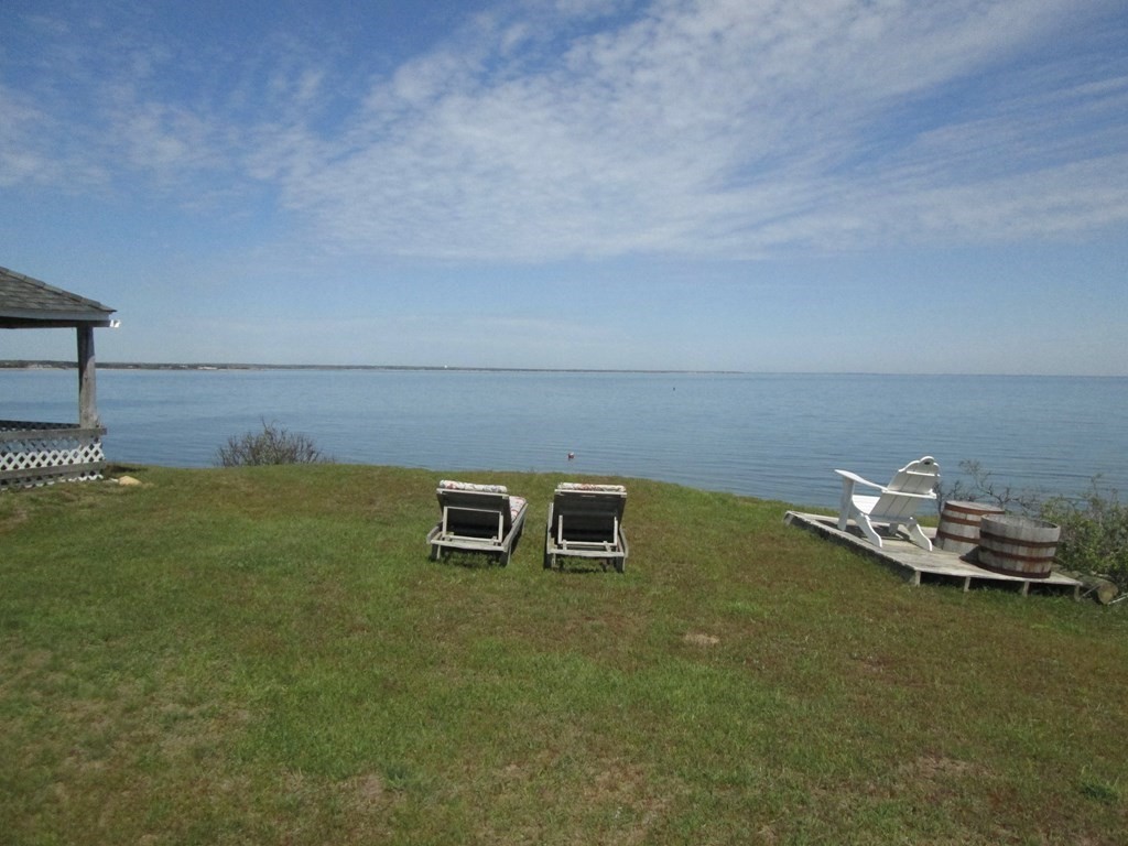 39 North Neck Road Edgartown, MA 02539 - Photo 4 of 26 a backyard with a table and chairs