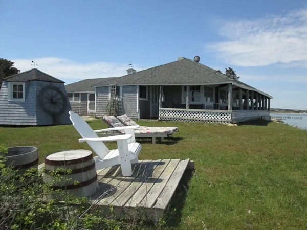 a view of a house with backyard sitting area and garden