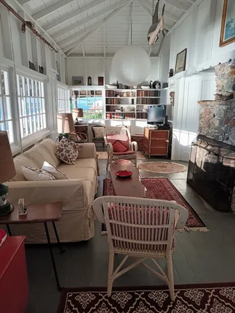 a living room with lots of furniture and a chandelier