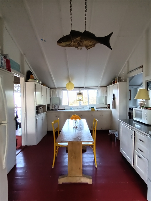 39 North Neck Road Edgartown, MA 02539 - Photo 10 of 26 a living room with stainless steel appliances kitchen island granite countertop lots of furniture and a wooden floors