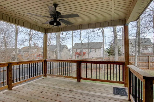 a view of a house with a yard and large tree