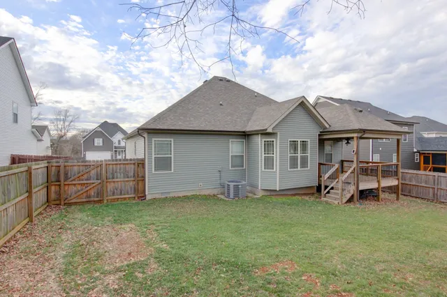 a view of a house with a yard and sitting area