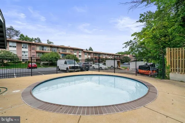 a view of a patio with chairs and table under an umbrella