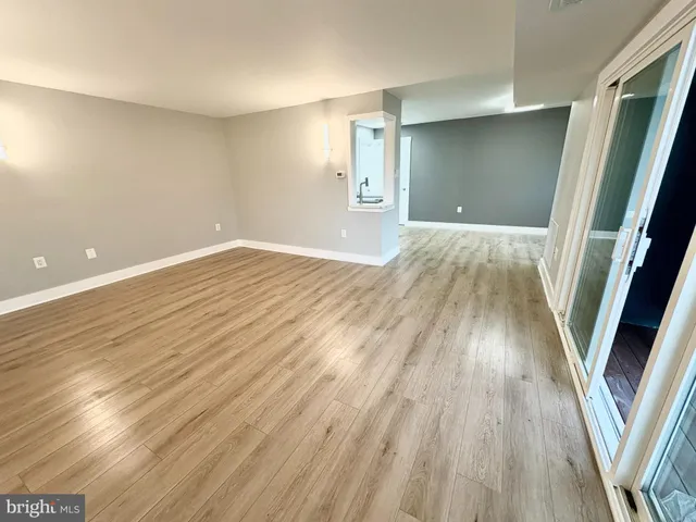 a view of a room with wooden floor and staircase