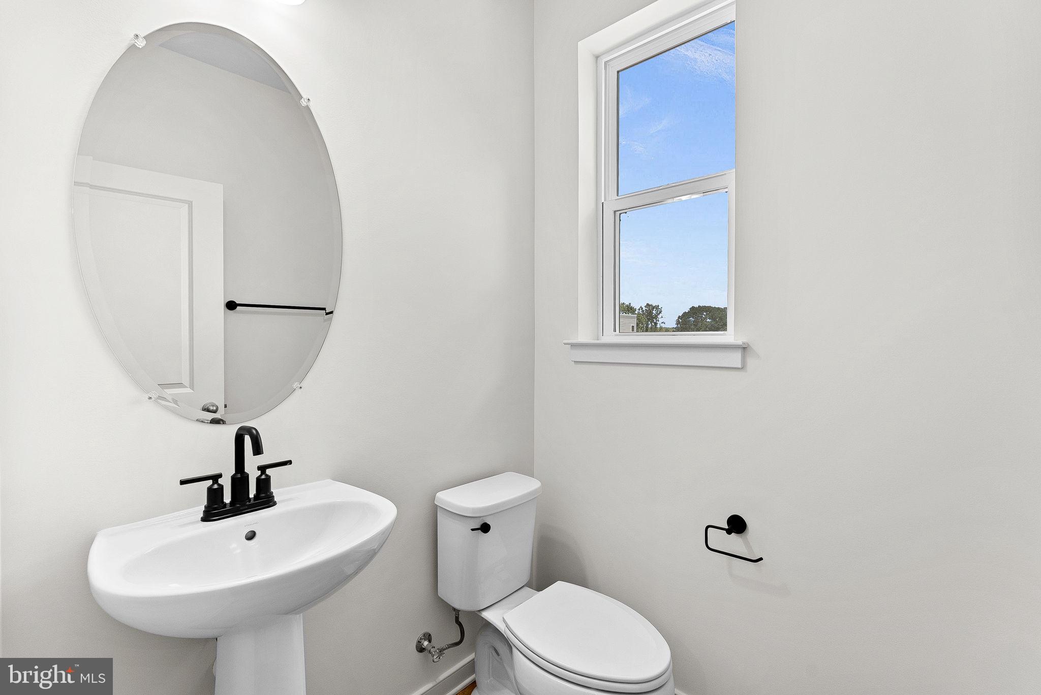 4151 Mountjoy Way Dumfries, VA 22026 - Photo 17 of 41 a bathroom with a sink a mirror and a toilet