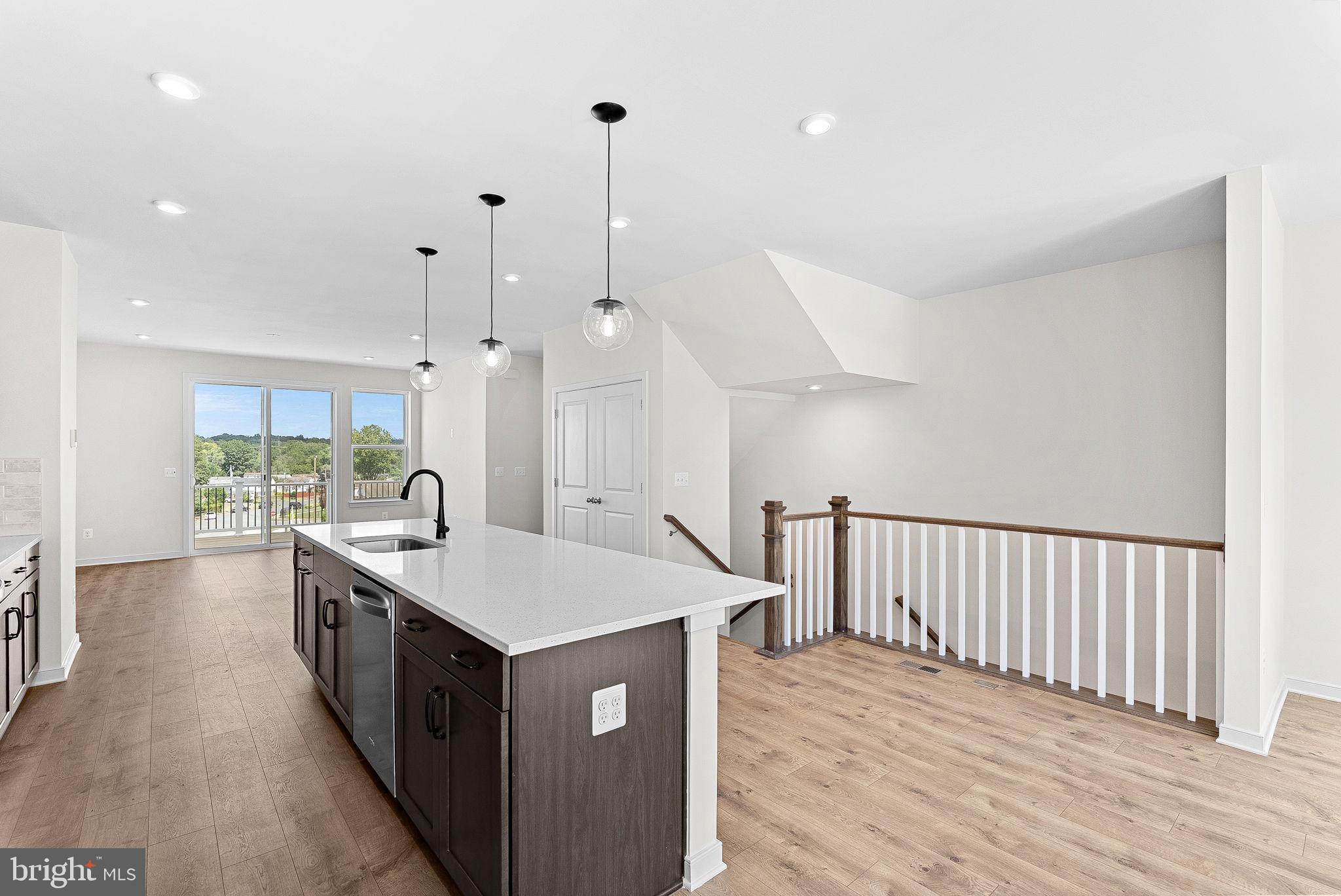 4151 Mountjoy Way Dumfries, VA 22026 - Photo 2 of 41 a kitchen with kitchen island a sink stove and wooden floor