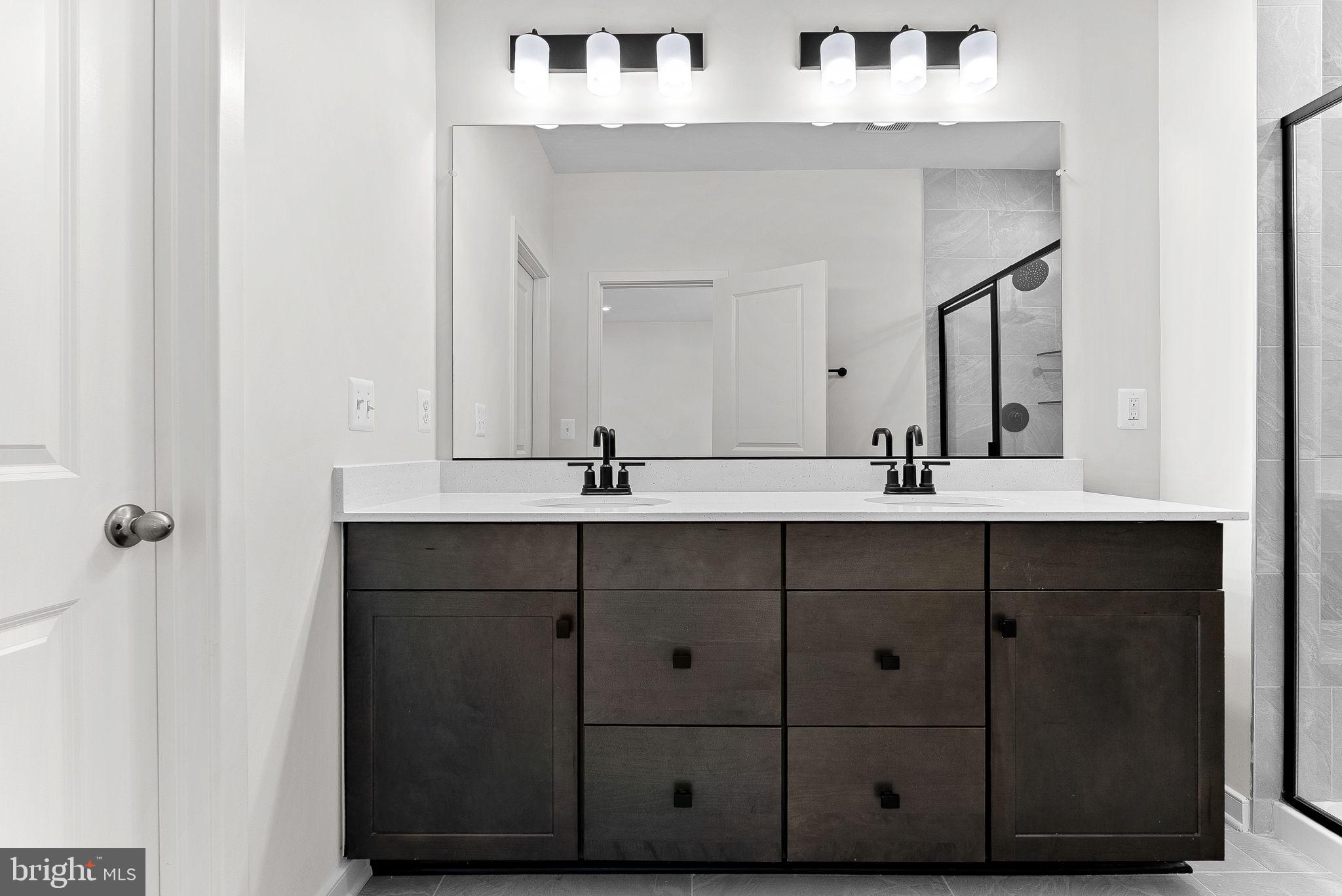 4151 Mountjoy Way Dumfries, VA 22026 - Photo 27 of 41 a bathroom with a double vanity sink and mirror
