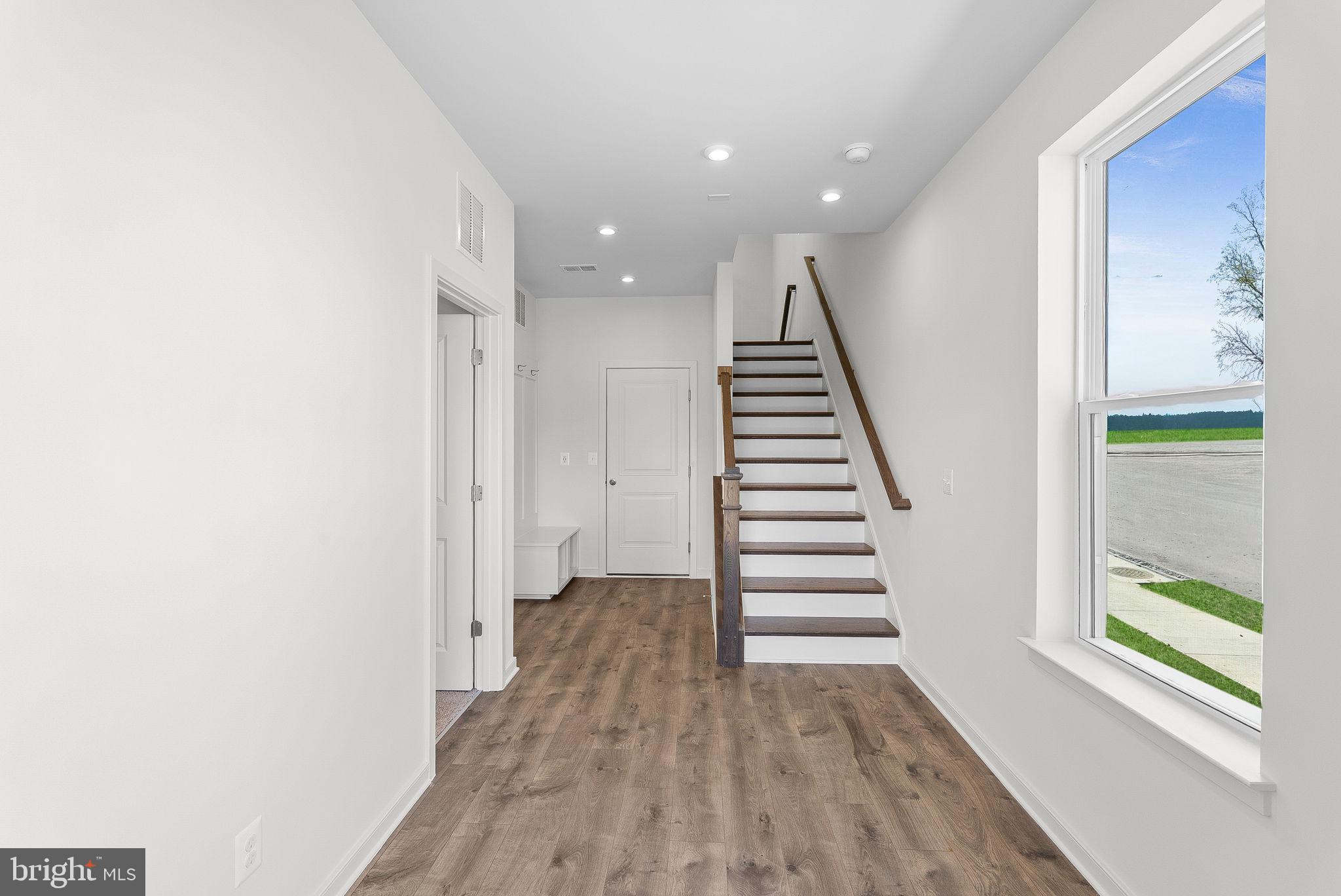 4151 Mountjoy Way Dumfries, VA 22026 - Photo 3 of 41 a view of a hallway with wooden floor and stairs