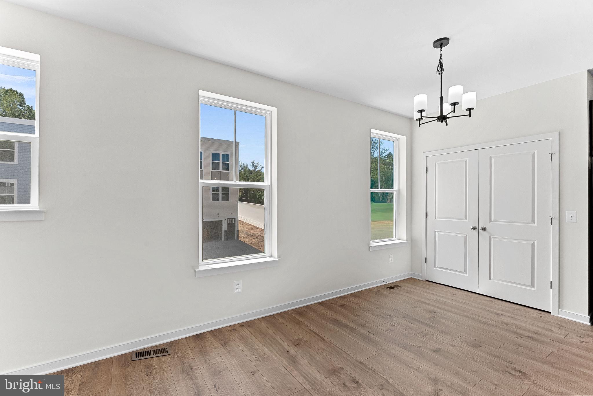 4151 Mountjoy Way Dumfries, VA 22026 - Photo 10 of 41 a view of empty room with wooden floor and windows