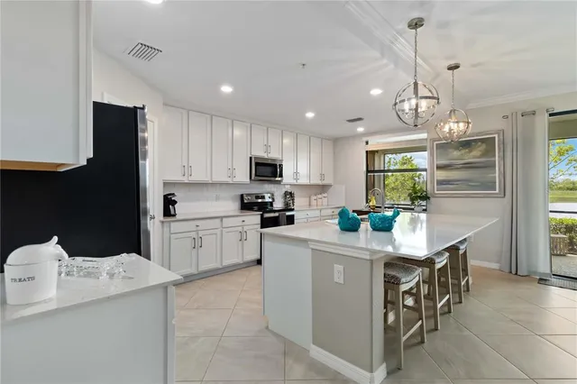 a kitchen with kitchen island a sink stainless steel appliances and cabinets