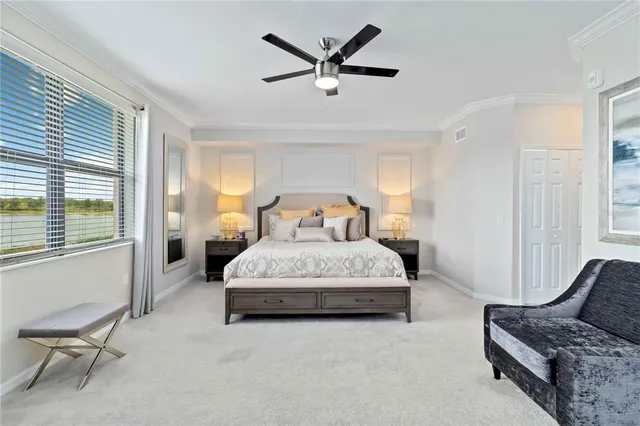 a living room with couch and a floor to ceiling window