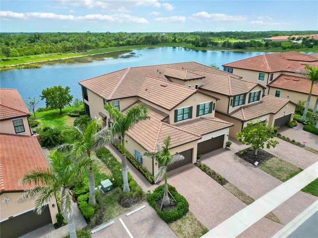 a view of swimming pool with outdoor seating and lake view