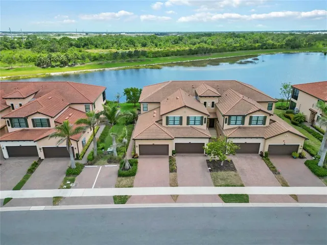 a aerial view of a multi story residential apartment building with a yard