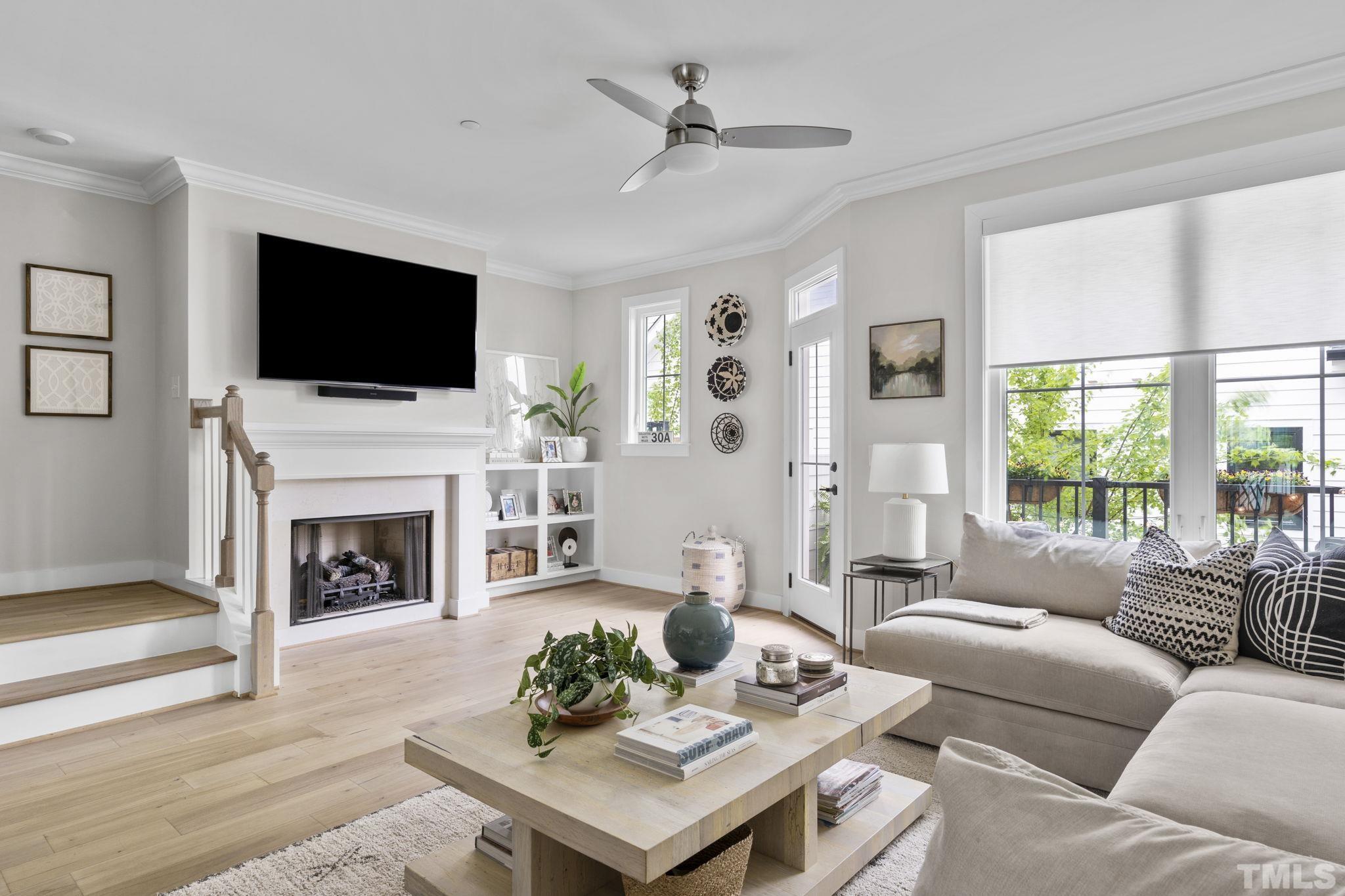 a living room with furniture a fireplace and a flat screen tv