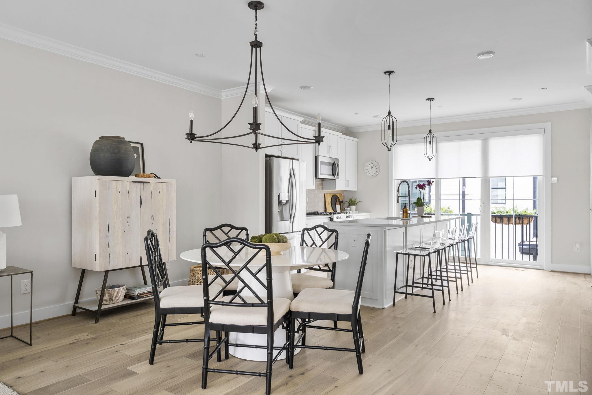 1610 Draper View Loop, Unit 104 Raleigh, NC 27608 - Photo 16 of 41 a view of a dining room with furniture and wooden floor