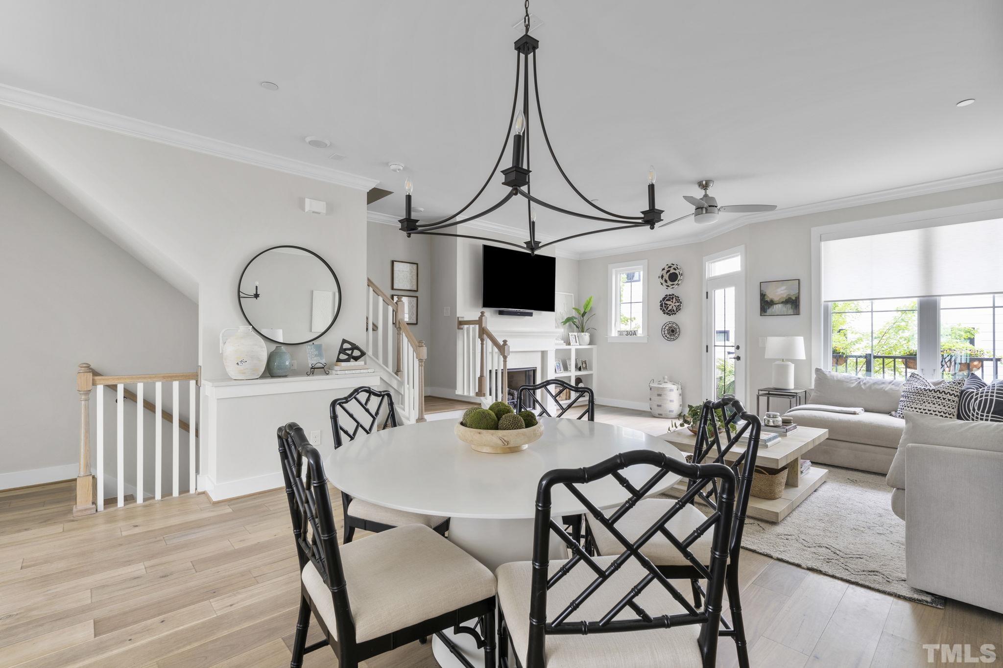 1610 Draper View Loop, Unit 104 Raleigh, NC 27608 - Photo 18 of 41 a view of a dining room with furniture and a chandelier