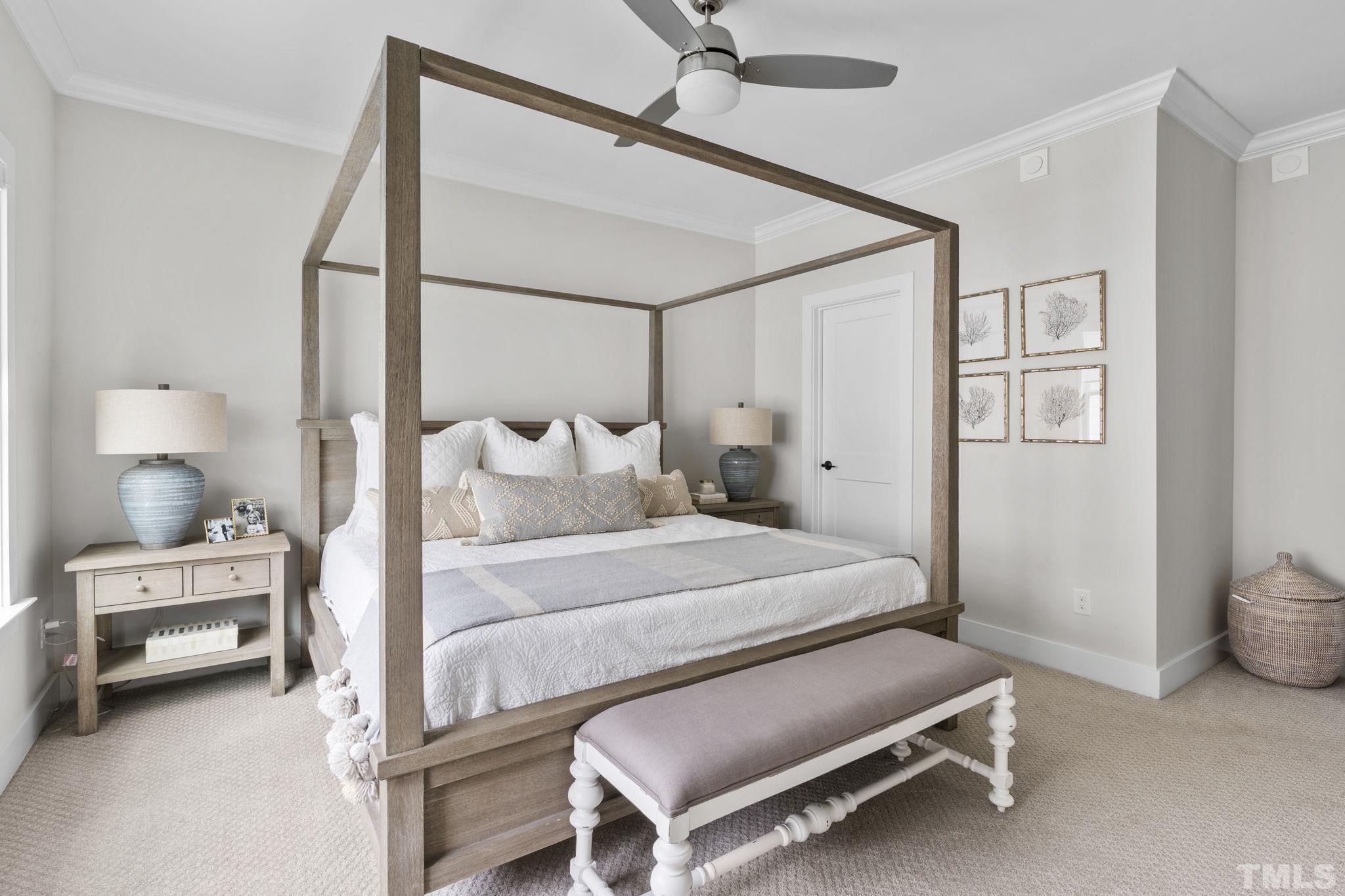 1610 Draper View Loop, Unit 104 Raleigh, NC 27608 - Photo 24 of 41 a bedroom with a bed and a chandelier