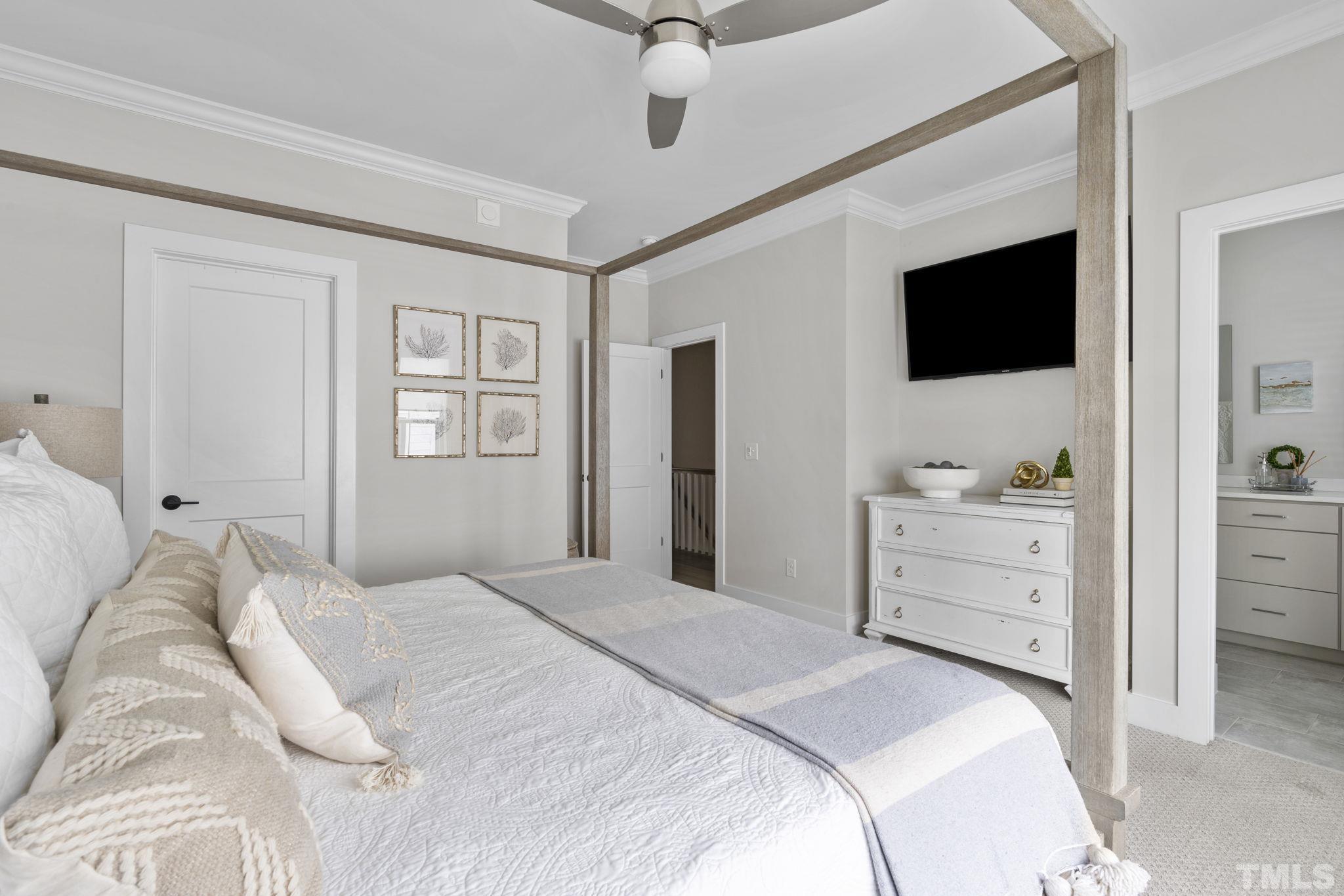 1610 Draper View Loop, Unit 104 Raleigh, NC 27608 - Photo 25 of 41 a bedroom with a bed and a flat screen tv