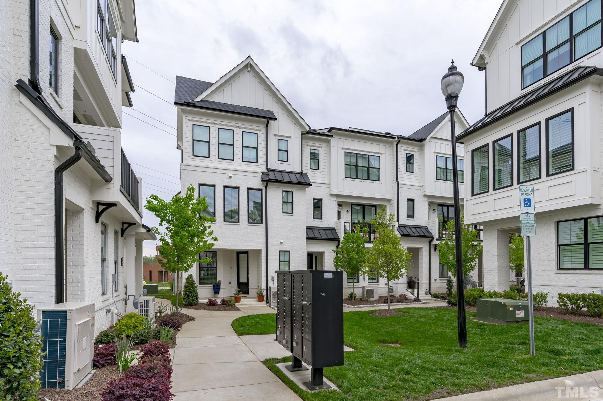 1610 Draper View Loop, Unit 104 Raleigh, NC 27608 - Photo 36 of 41 a front view of a residential apartment building with a yard