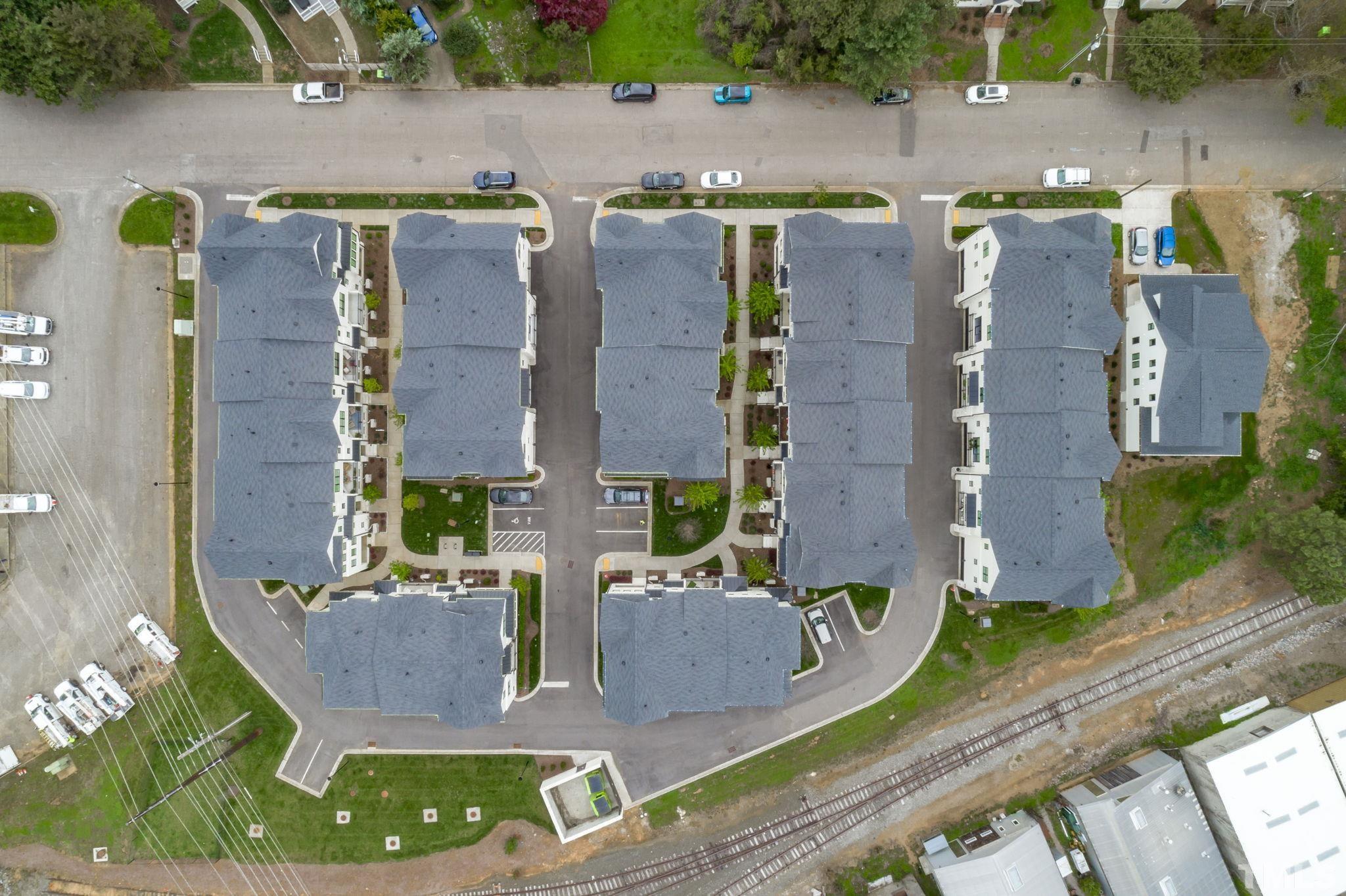 1610 Draper View Loop, Unit 104 Raleigh, NC 27608 - Photo 37 of 41 an aerial view of residential houses with outdoor space and parking