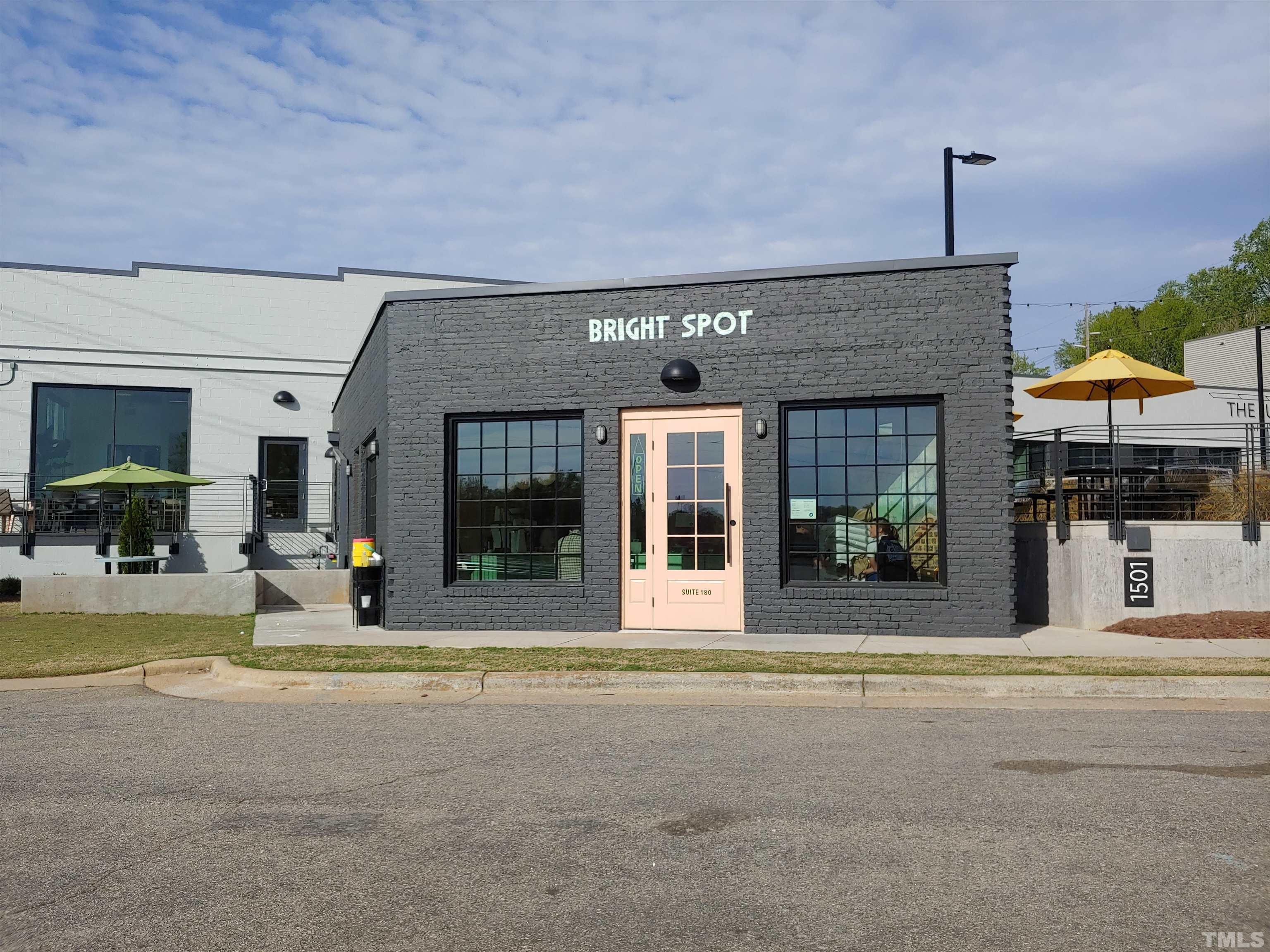 1610 Draper View Loop, Unit 104 Raleigh, NC 27608 - Photo 39 of 41 a view of a building with sitting area and garden
