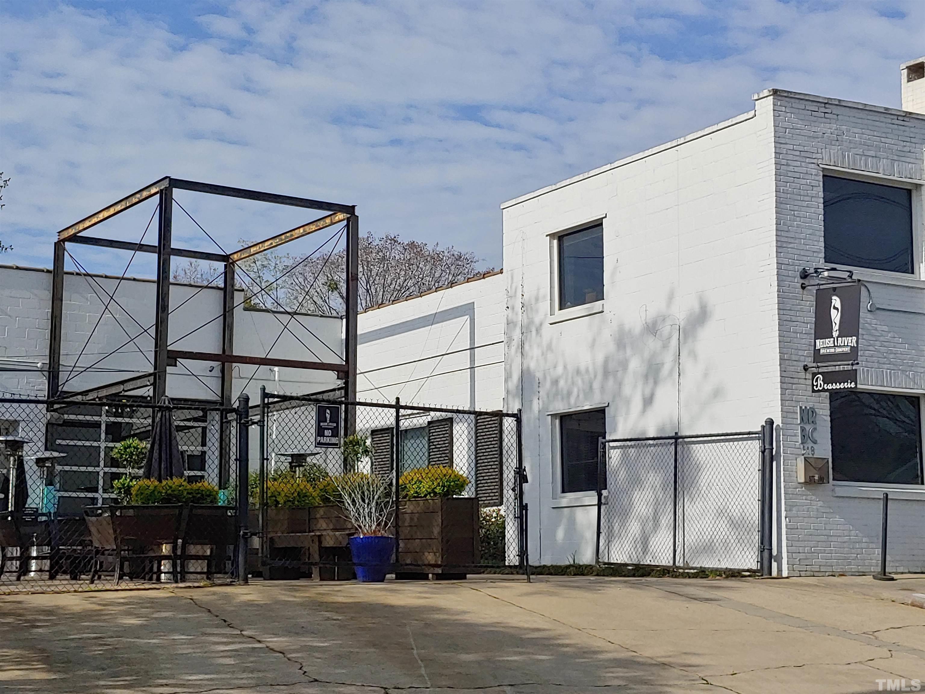 1610 Draper View Loop, Unit 104 Raleigh, NC 27608 - Photo 40 of 41 a view of a brick building next to a road