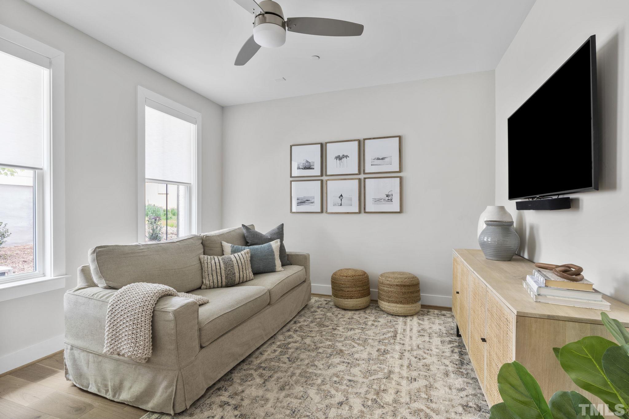 1610 Draper View Loop, Unit 104 Raleigh, NC 27608 - Photo 6 of 41 a living room with furniture and a flat screen tv