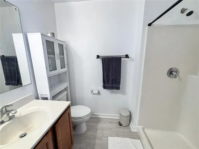 a bathroom with a sink toilet and shower